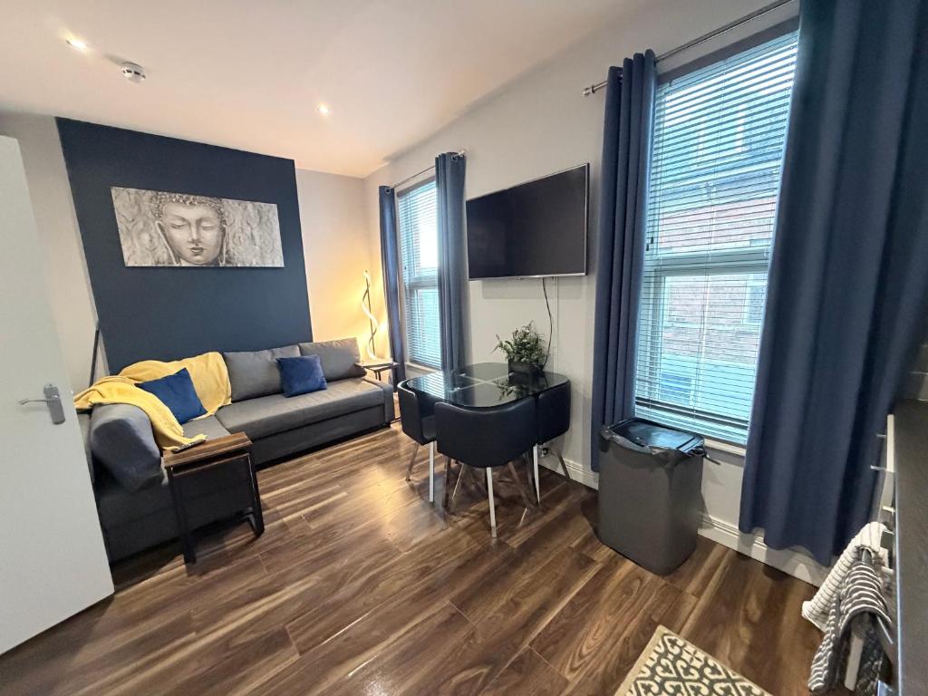 a living room with a couch and a table at Harvey Apartments in Derry Londonderry