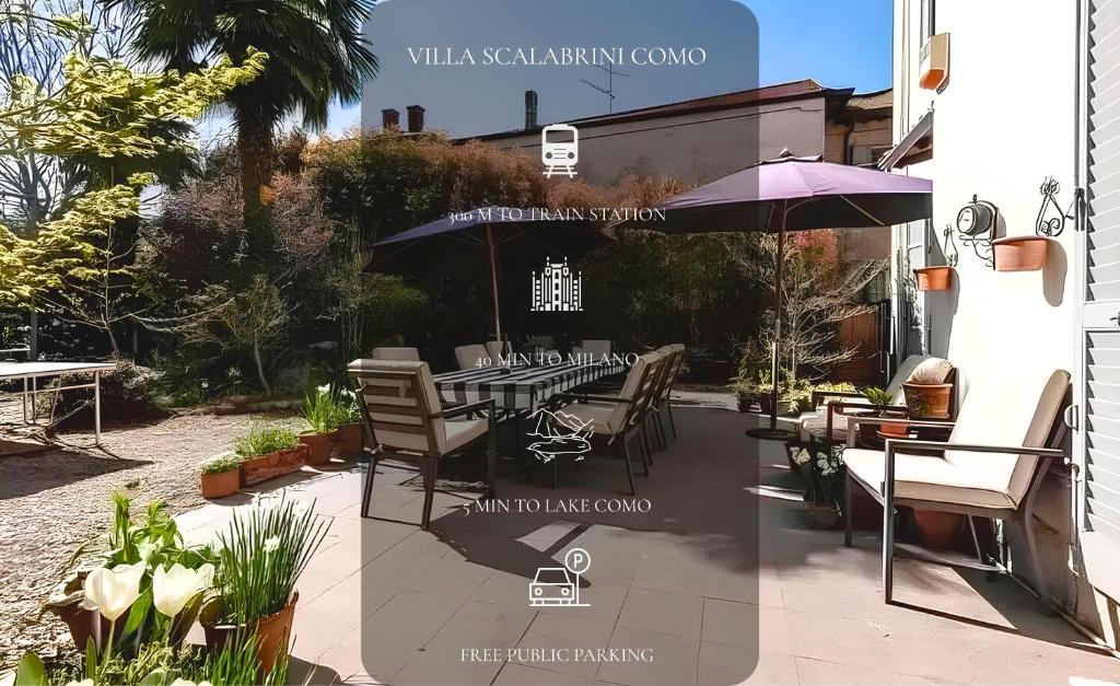 a patio with a table and chairs and an umbrella at Villa Scalabrini in Como