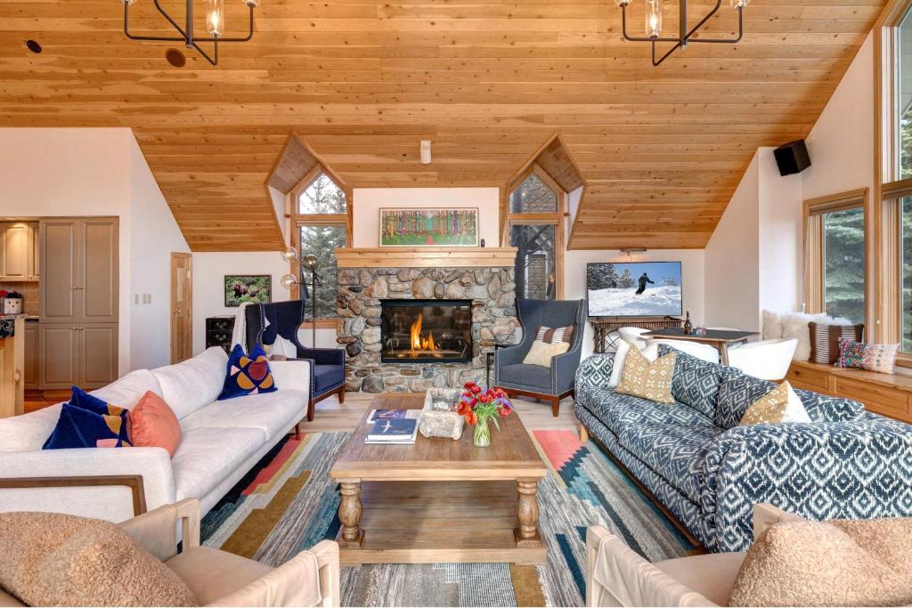 a living room with couches and a fireplace at Abode at Golden Spruce in Wilson