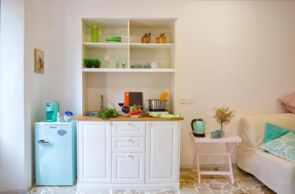 a kitchen with a blue refrigerator in a room at Plaza Suites in Piazza Armerina