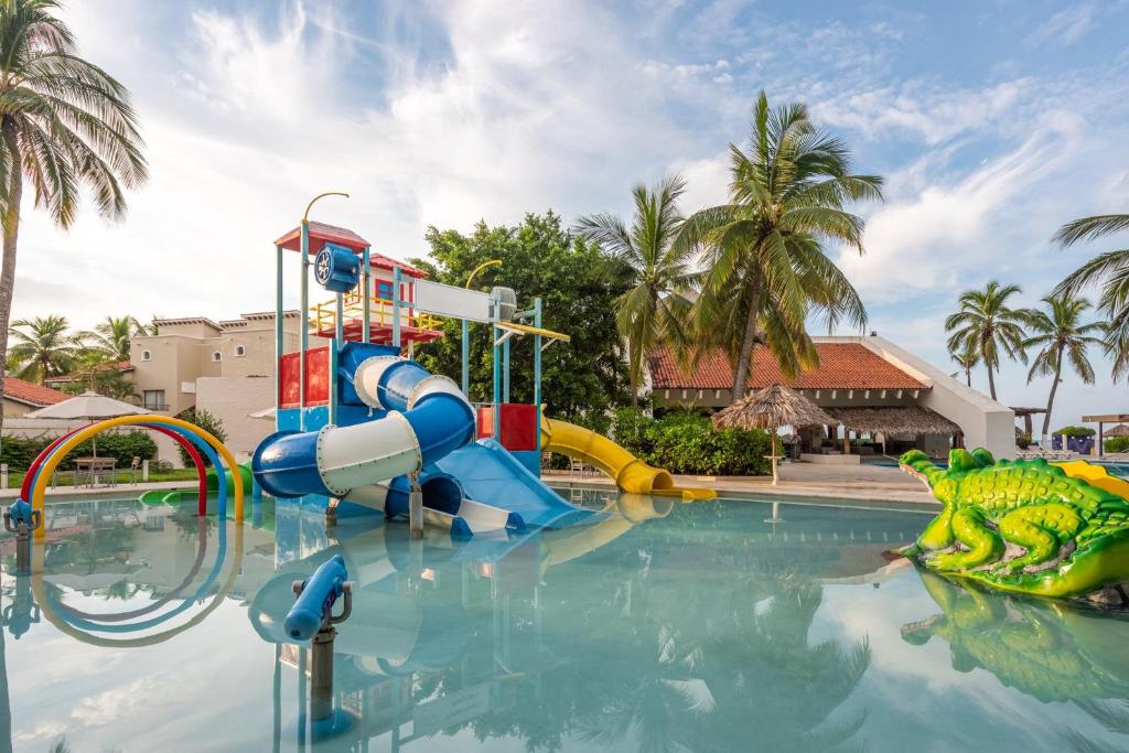 a pool with a water park with a water slide at Park Royal Beach Ixtapa - All Inclusive in Ixtapa
