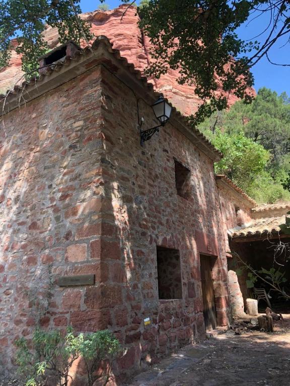 an old brick building with a roof at Molino Santiago in Torre de las Arcas