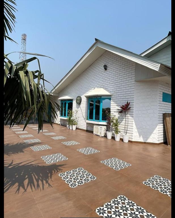 a house with a patio with white and black tiles at Karma Stay 2BHK apartments in Jaigaon