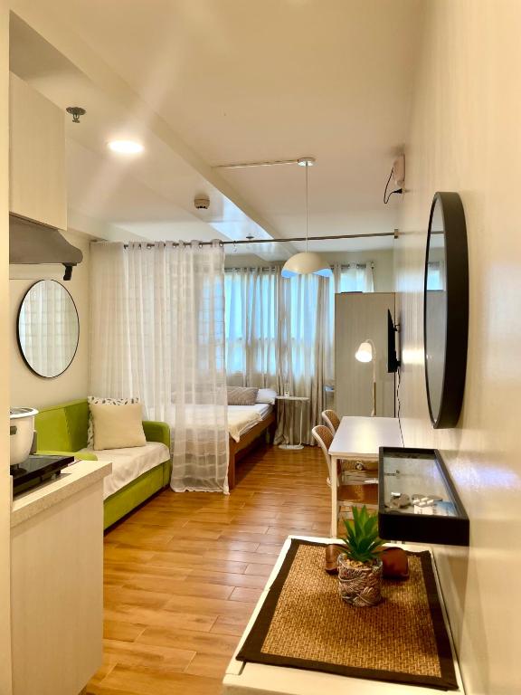 a kitchen and a living room with a couch at Marrione's Pad in Davao City