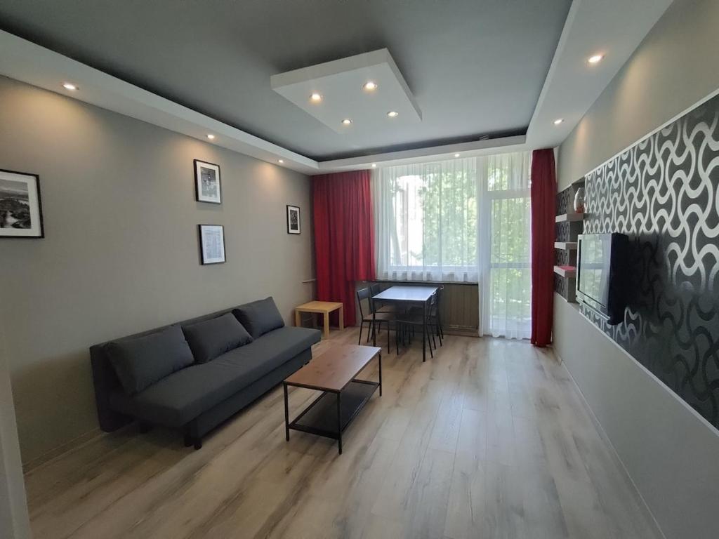 a living room with a couch and a table at Városközpont Tata in Tata