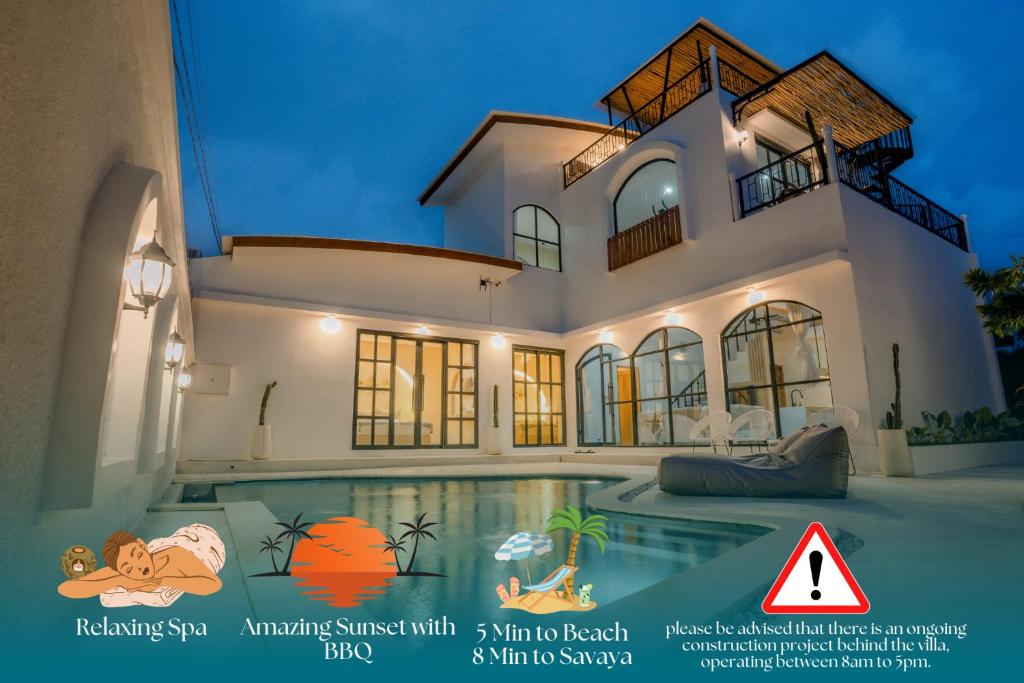 a house with a swimming pool in front of it at Casa Karuna Villa in Jimbaran