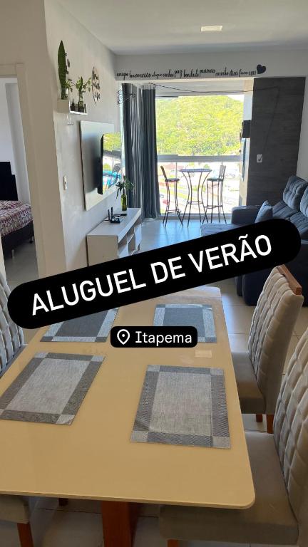a living room with a yellow table and chairs at Ap Alto São Bento in Itapema