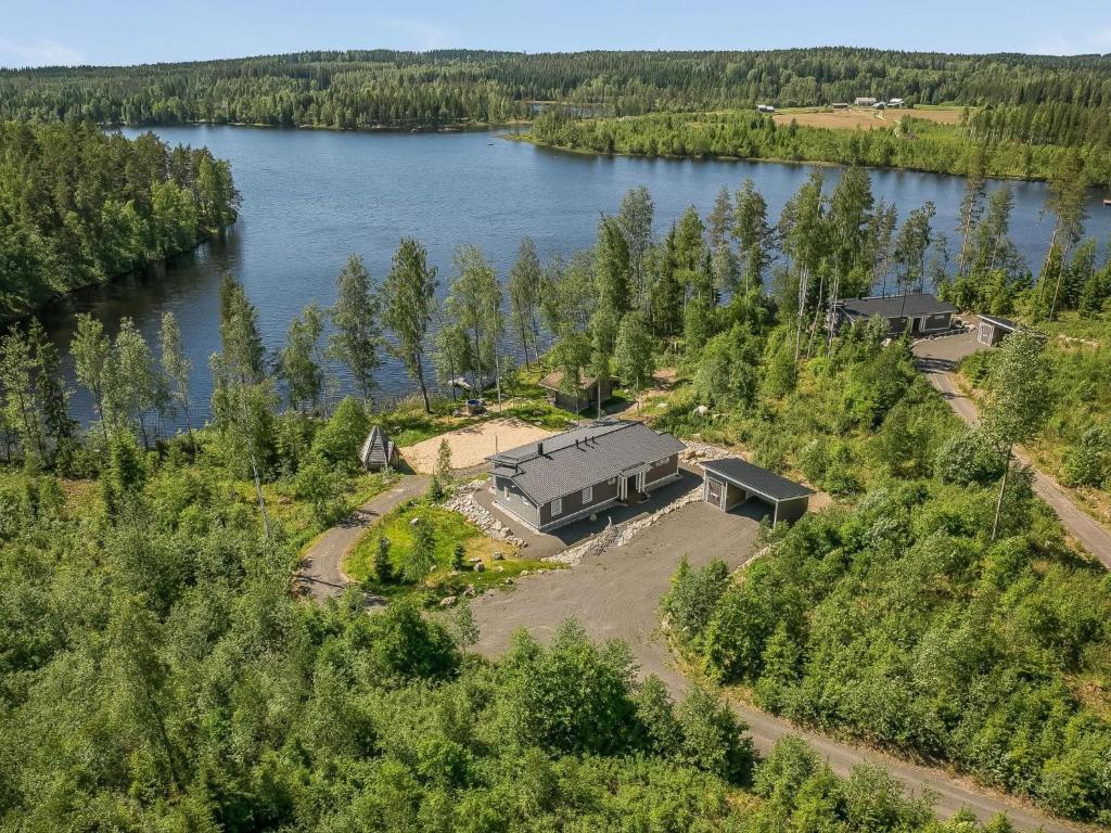 an aerial view of a house next to a lake at Holiday Home Riemukaari by Interhome in Lihavanpää
