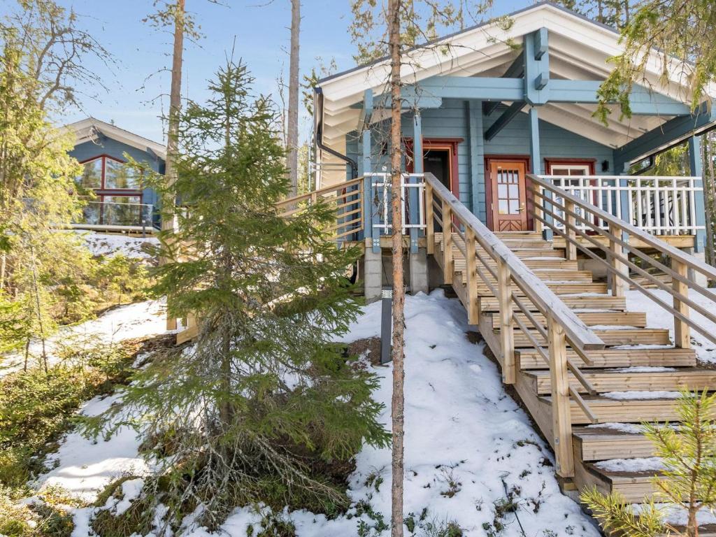 a house in the woods with snow on the ground at Holiday Home Klippan by Interhome in Tuuhonen