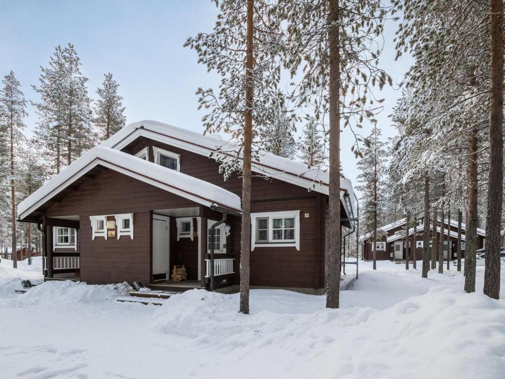 a log cabin in the woods in the snow at Holiday Home Albatrossi by Interhome in Levi