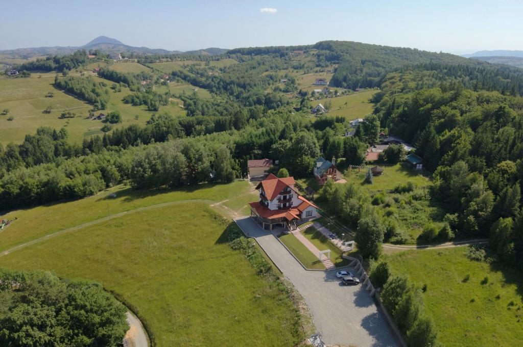 an aerial view of a house in the middle of a field at Pensiunea BriAdda in Poiana Mărului