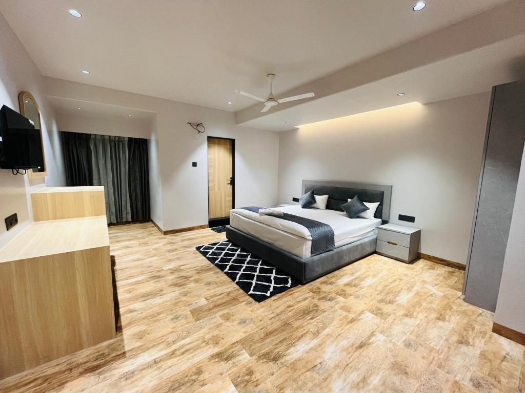 a bedroom with a bed and a television in it at Hotel City View in Golāghāt