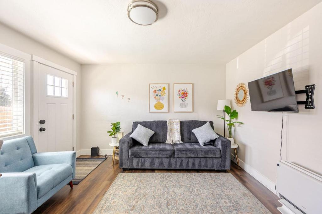 a living room with a couch and a tv at 721 Cozy Mid-Town Hideaway in Reno