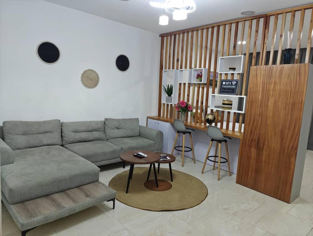 a living room with a couch and a table at Bark luxury apartments Abidjan Attoban 2 in Abidjan