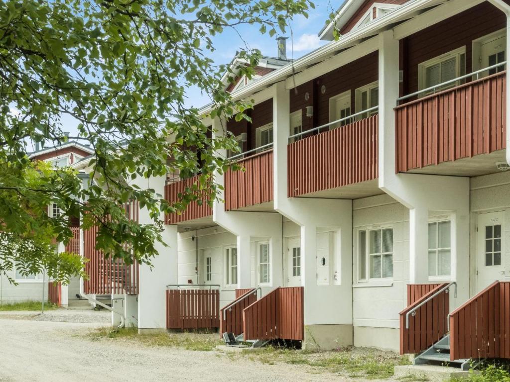 a row of apartment buildings with red balconies at Holiday Home Levi star 1502 by Interhome in Levi