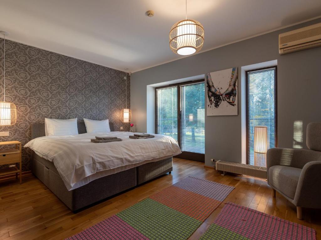 a bedroom with a bed and a couch and windows at Pikk 45 in Otepää