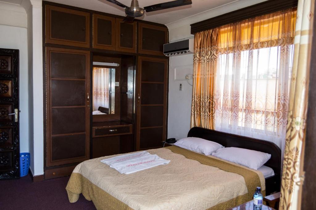 Postel nebo postele na pokoji v ubytování Manson Hotel