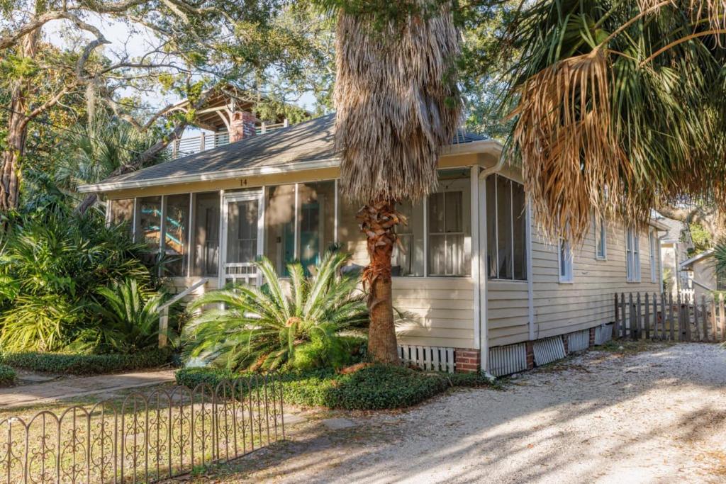 a white house with a palm tree in front of it at Cabin in Tybee Island, Georgia in Tybee Island