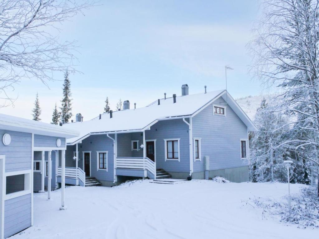 a house with snow on the ground in front of it at Holiday Home Pulkka 1 by Interhome in Salla