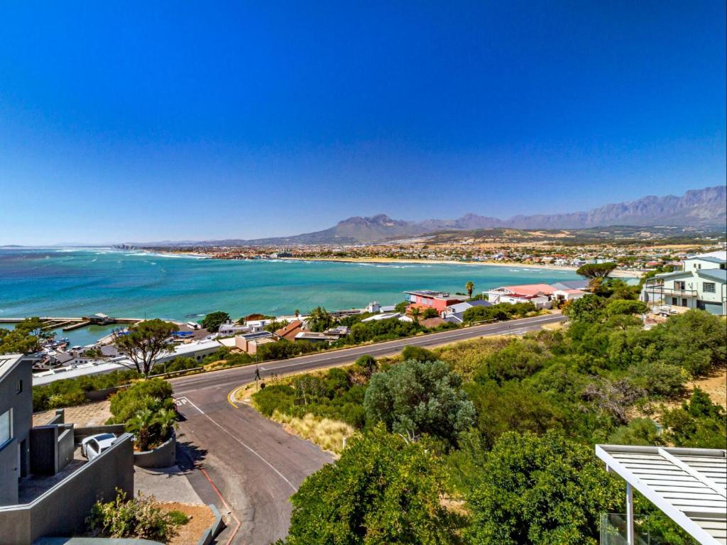 an aerial view of a city and the ocean at 5 Suikerbossie in Gordonʼs Bay