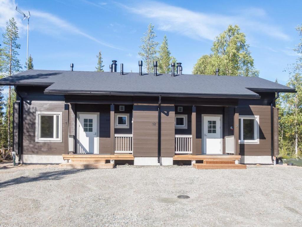 a small house with a black roof at Holiday Home Kitkanvee 1 by Interhome in Kuusamo