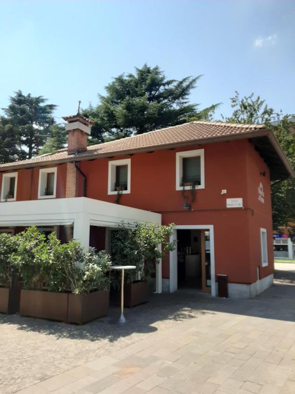 a red and white building with a courtyard at Osteria Al Ponte in Udine