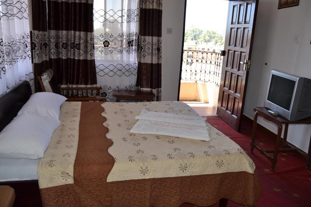 Postel nebo postele na pokoji v ubytování Manson Hotel