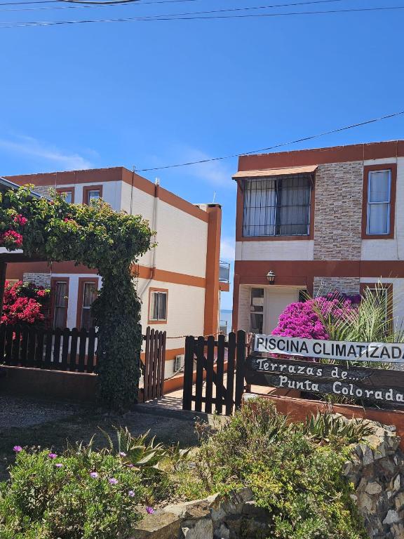 a sign in front of a building at Terrazas De Punta Colorada in Piriápolis