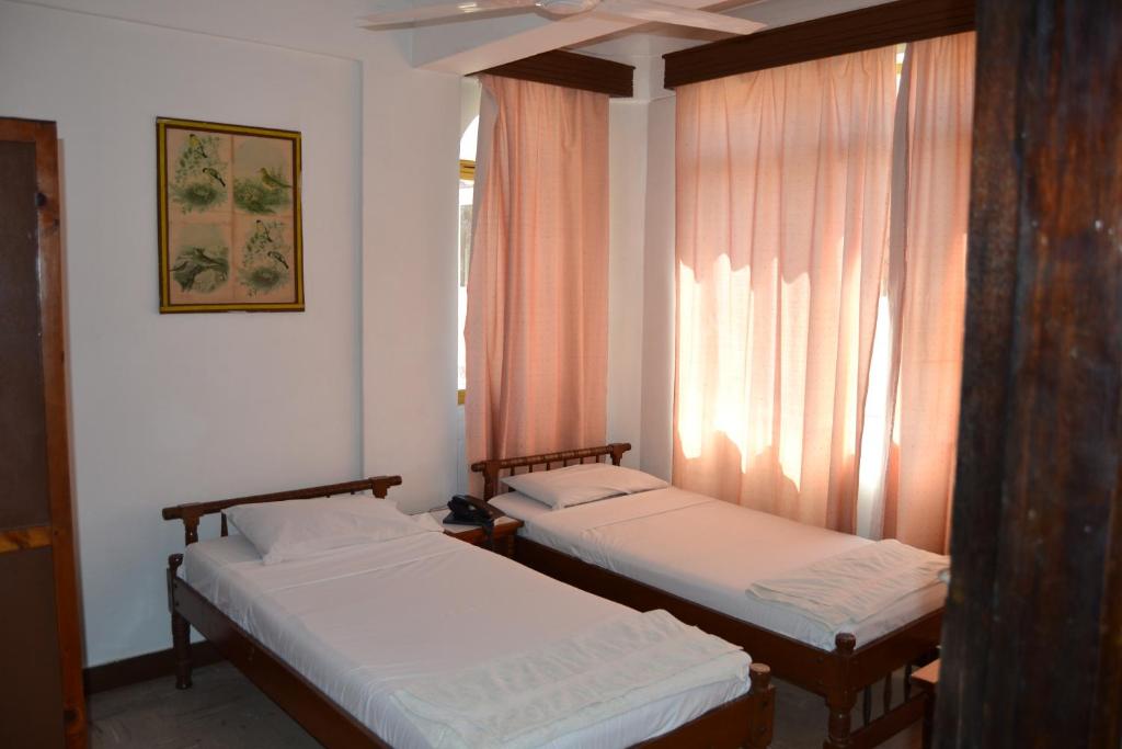 Postel nebo postele na pokoji v ubytování Manson Hotel