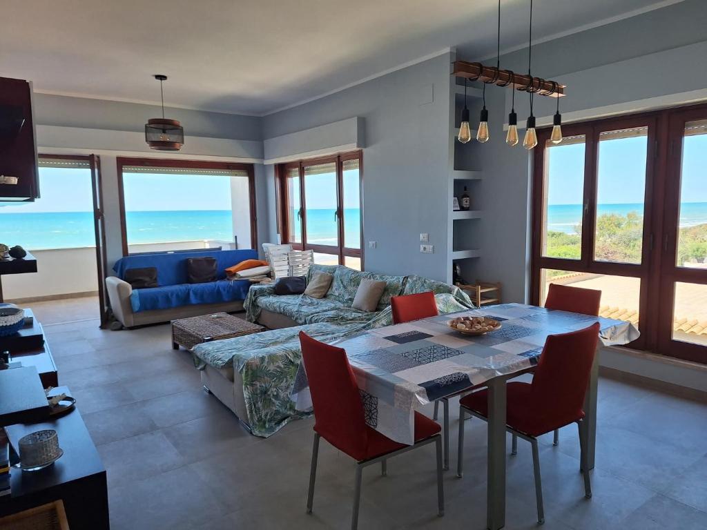 a living room with a table and a couch at My Sunset in Torvaianica