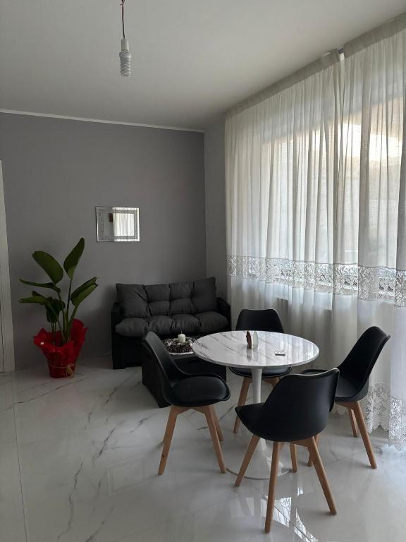 a living room with a table and chairs and a couch at BEB LA Perla in Sammichele di Bari