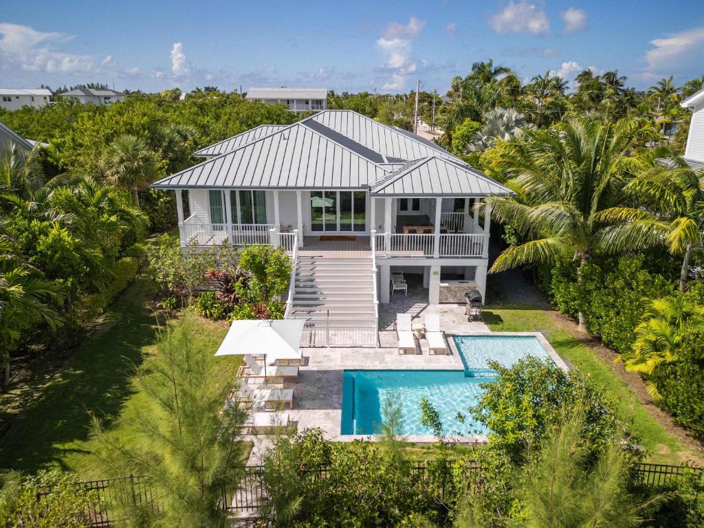 an aerial view of a house with a swimming pool at Springtide House -Dock & Home w Pool in Stock Island