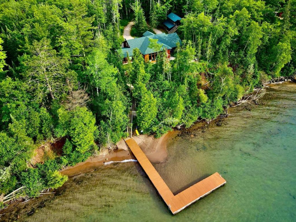 an aerial view of a house next to a river at Sunset Bay Lodge in Abbeyville