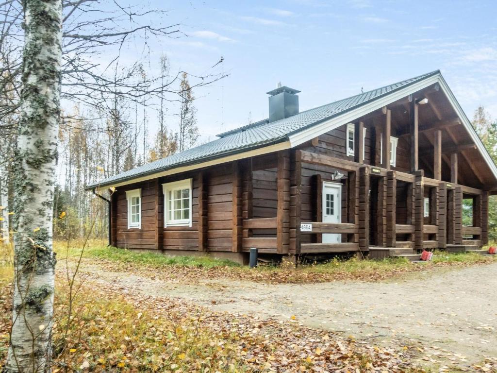 a log cabin in the woods with a tree at Holiday Home Kranni 1 by Interhome in Syöte