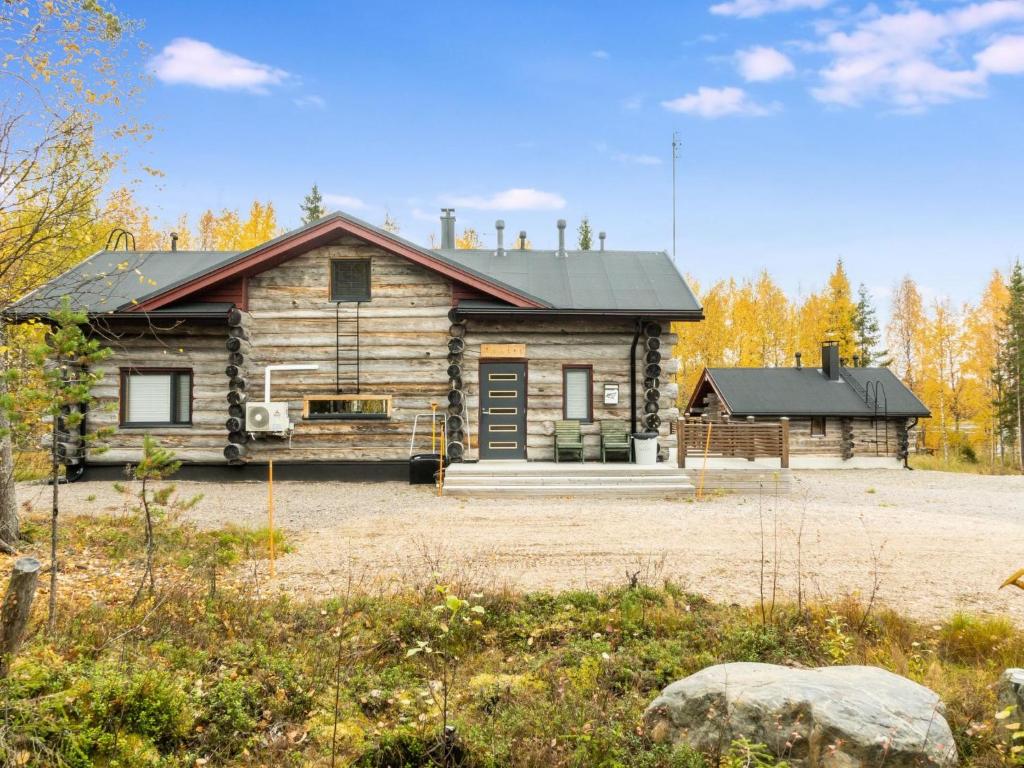 a log cabin in the middle of a field at Holiday Home Kojamopirtit by Interhome in Kolari
