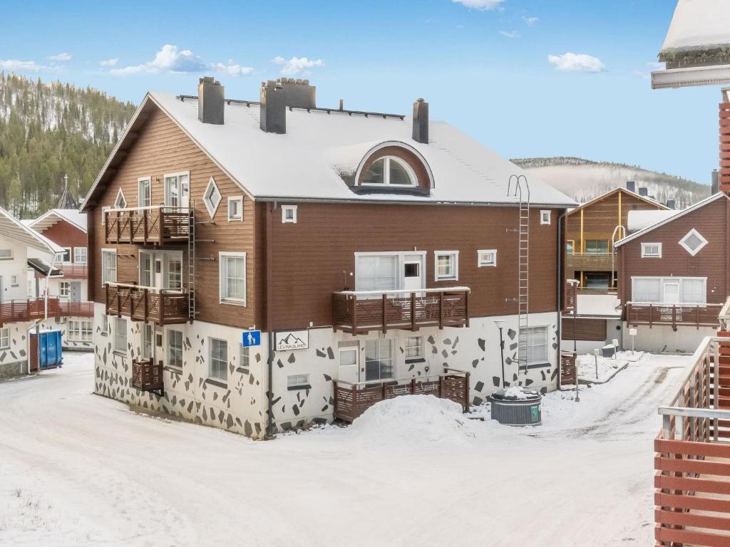 a building covered in graffiti in the snow at Holiday Home Levinkolmio c6 by Interhome in Levi
