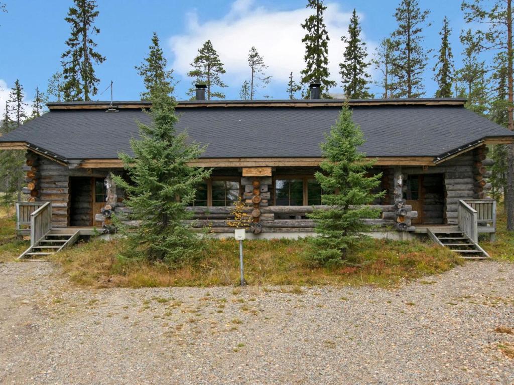 a log cabin with trees in front of it at Holiday Home Joikupirtti a by Interhome in Pyhätunturi