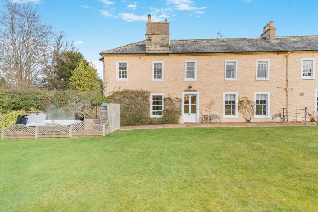 a large house with a lawn in front of it at 4 Bed in Armathwaite oc-e34641 in Armathwaite