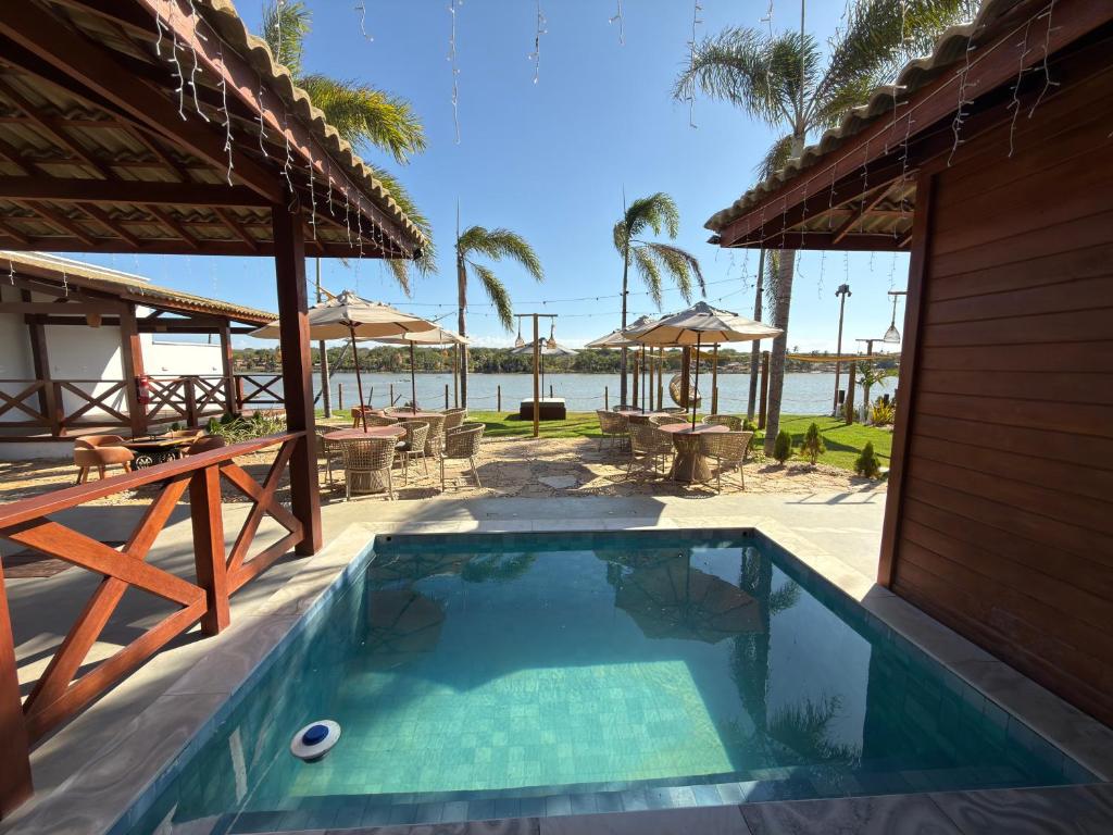 a swimming pool with a view of the water at Lagoon Paradise in Fortim