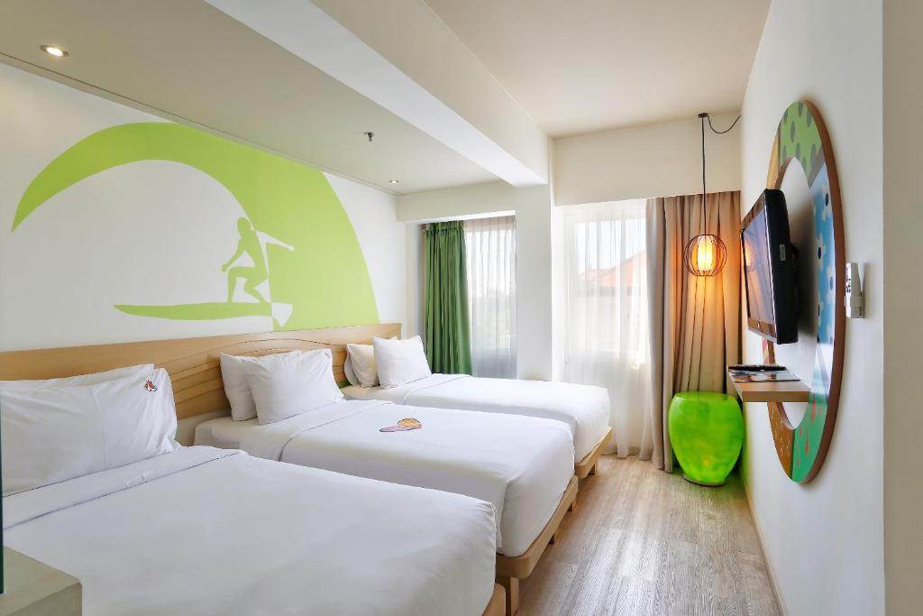 Postel nebo postele na pokoji v ubytování MaxOneHotels at Bukit Jimbaran