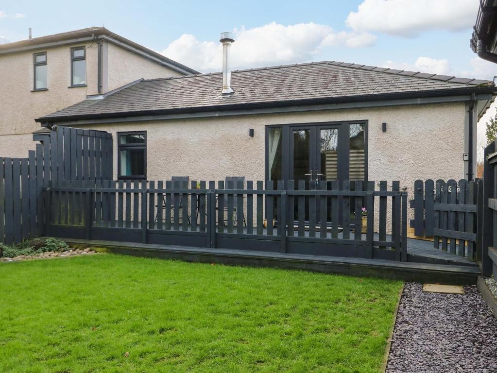 a wooden fence in front of a house at Hafod Wen in Pentraeth
