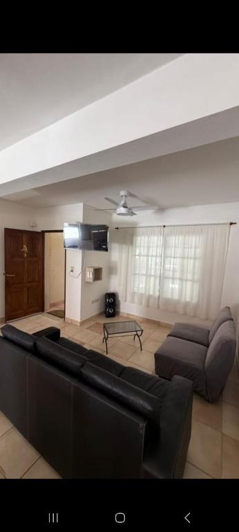 a living room with a couch and a table at Bela house in Concepción del Uruguay