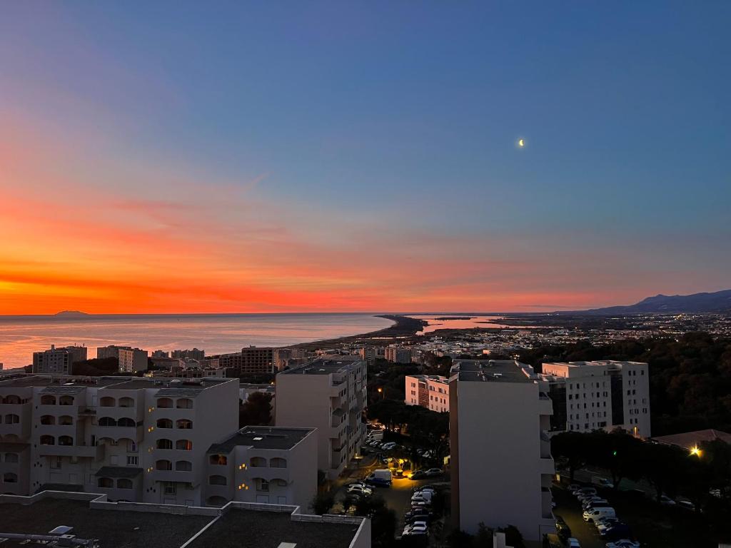 a view of a city at sunset at Très bel appartement in Bastia