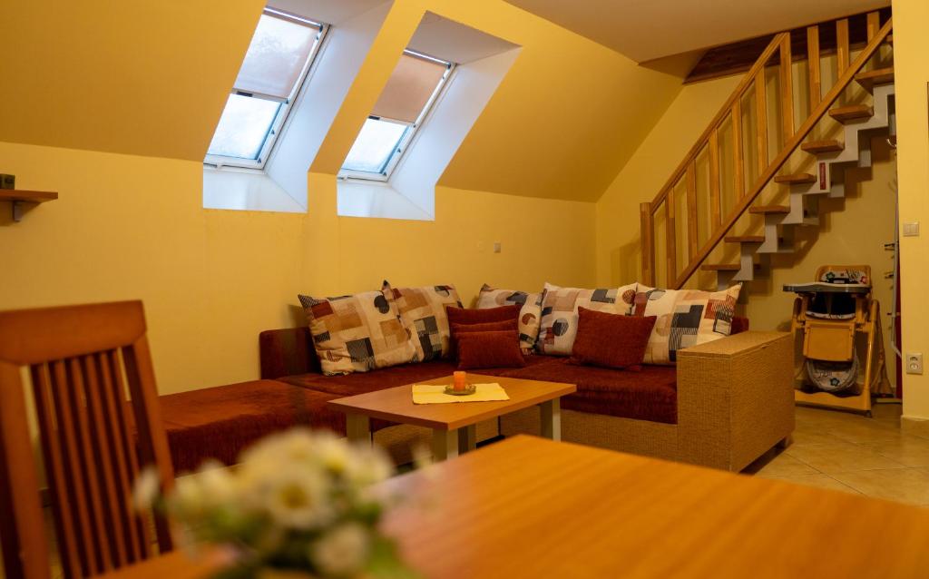 a living room with a couch and some windows at Vanilka in Liptovský Trnovec