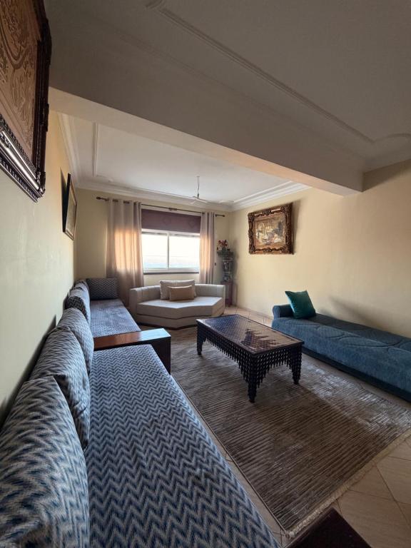 a living room with a couch and a table at Entire Ocean-View Apartment in Rabat