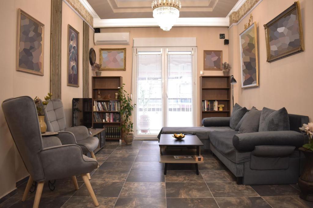 a living room with a couch and chairs and a table at Galleria Home in Serres