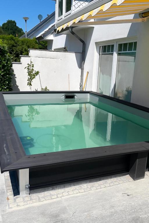a swimming pool in front of a house at 4 Zimmer Ostseetraum in Gneversdorf