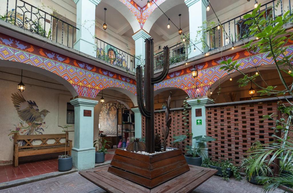 a lobby of a building with a bench in the middle at Selina Oaxaca in Oaxaca City