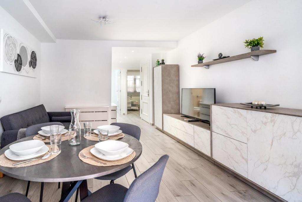a dining room with a table and chairs and a tv at Apartamento Ponent Stays in Almacellas