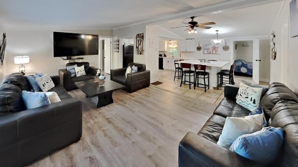 a living room with a leather couch and a table at Put-in-Bay Island Club #66 in Put-in-Bay